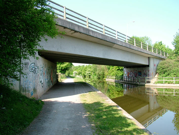 A nondescript modern bridge with graffiti