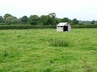 A lone shed in a field
